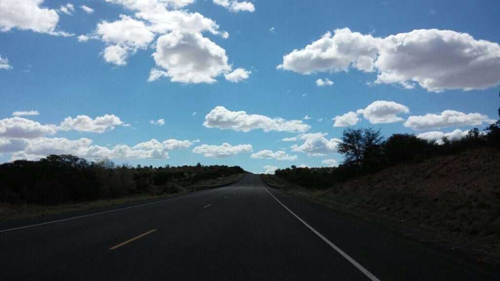 Long road with blue skies